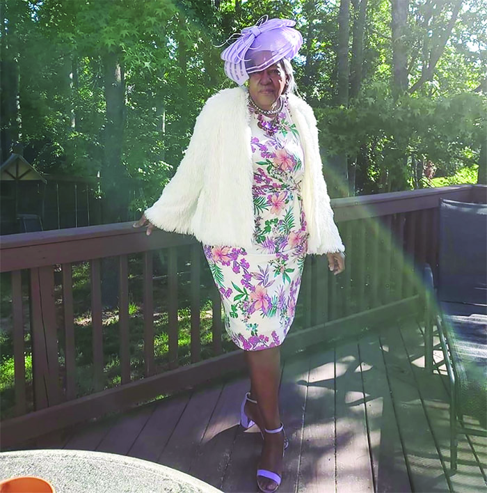 Mother in white floral dress on deck