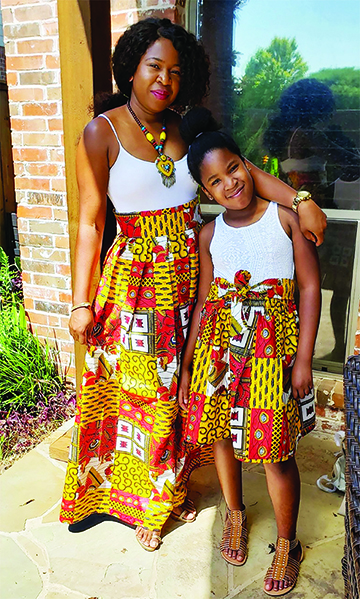 Mom and daughter in kente skirts
